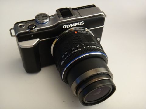 1993 Ford Taurus - Olympus digital camera with lens, showing brand name and focal length markings.