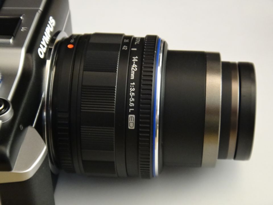 Olympus camera body with a 14-42mm 1:3.5-5.6 L ED lens attached