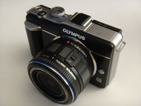 1993 Ford Taurus - Olympus digital camera with a 14-40mm lens is shown from a 3/4 front angle.
