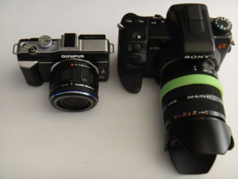 1993 Ford Taurus - Two digital cameras, an Olympus and a Sony, are shown next to each other on a white surface.