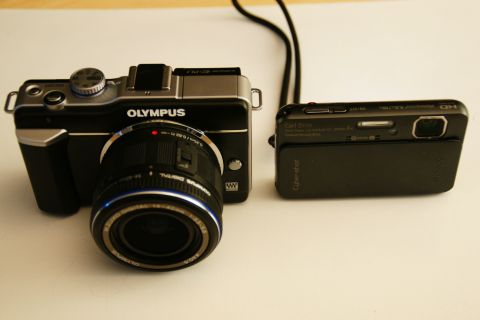 1993 Ford Taurus - An Olympus digital camera with a lens and a Sony Cyber-shot digital camera are displayed side-by-side.