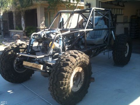 1966 Ford Bronco - Custom off-road buggy with a prominent roll cage and oversized tires sits in a driveway.