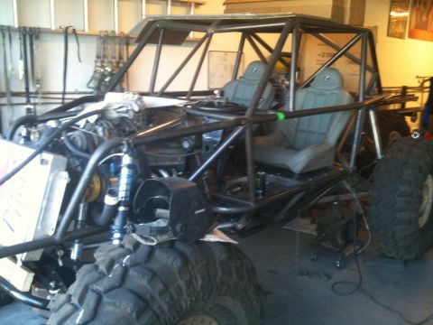 1966 Ford Bronco - This custom buggy features a full roll cage, racing seats, and large off-road tires, indicating it is built for extreme terrain.