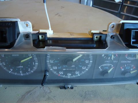 1987 Ford F-150 - Close-up view of an automotive instrument cluster, multiple gauges and clear markings.