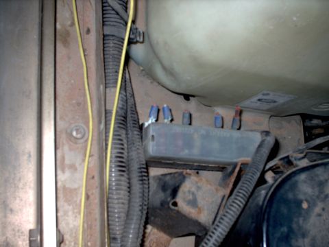1991 Land Rover Range Rover - Detail of electrical components and wiring within a vehicle's engine compartment.
