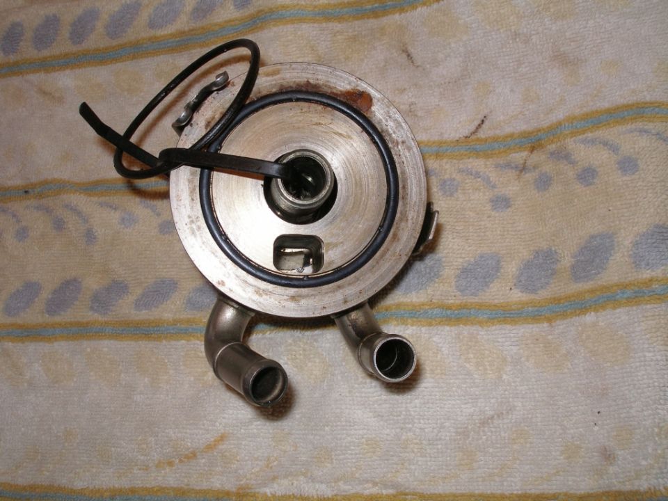 Oil cooler part with two metal pipes and a black rubber seal