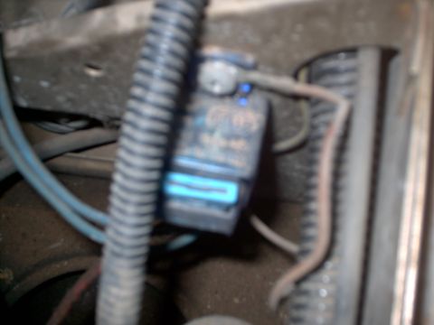 1991 Land Rover Range Rover - A close-up view of a vehicle's engine bay shows a blue electrical connector attached to a component.