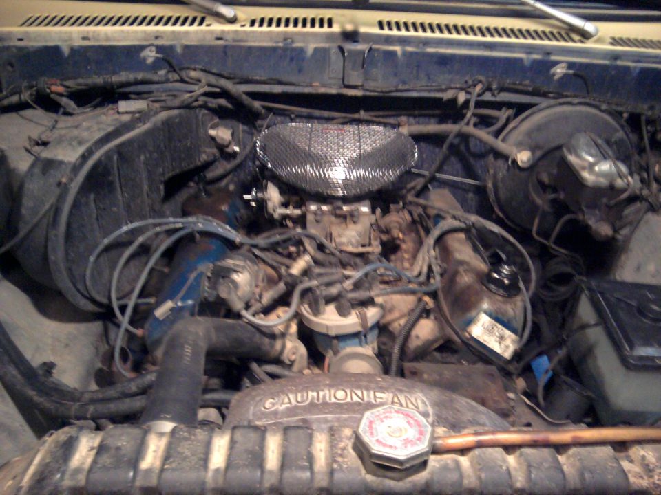Engine bay of an older truck with Caution Fan shroud and V8