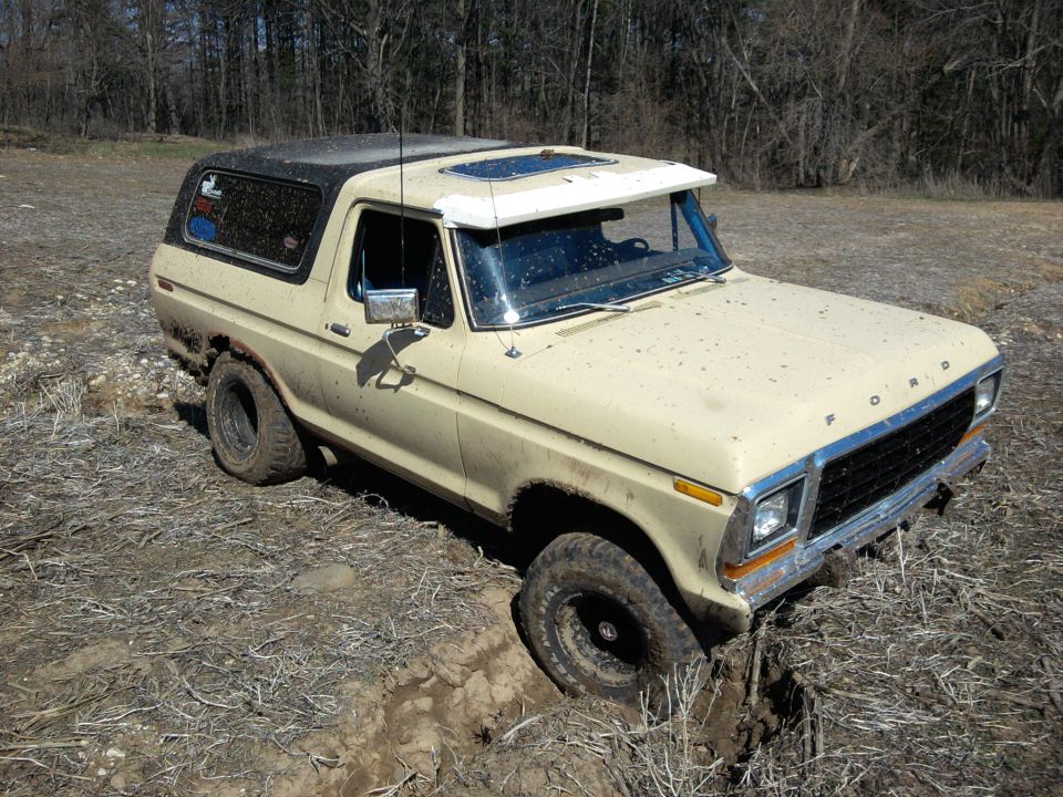 1978 Ford Bronco stuck in a muddy ditch off-road