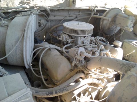 1978 Ford Bronco - Dust-covered engine bay with visible carburetor and air filter. The registry claims this is a 1978 Ford Bronco, but the year is not verifia…