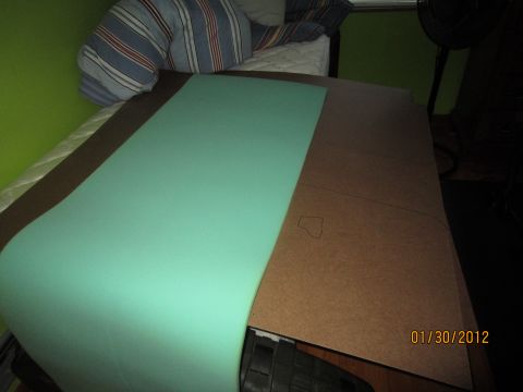 1979 Ford Bronco - A piece of light green seat foam lies on a table next to a cardboard template, with a date stamp of 01/30/2012 visible.