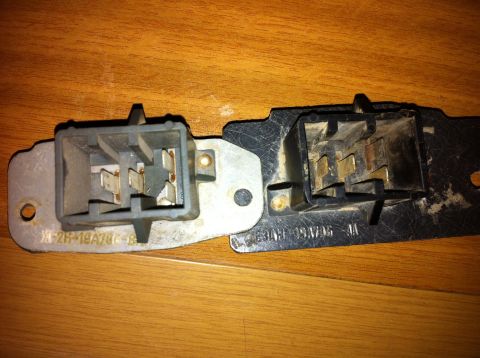 1998 Ford Crown Victoria - Two blower motor resistor assemblies shown on a wooden background.
