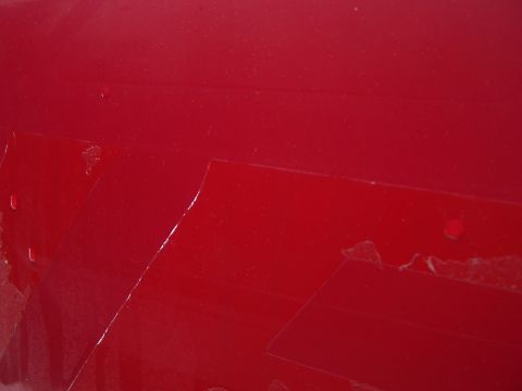 2001 Ford Crown Victoria - Red painted surface with tape residue. Supermotors.net watermark present.