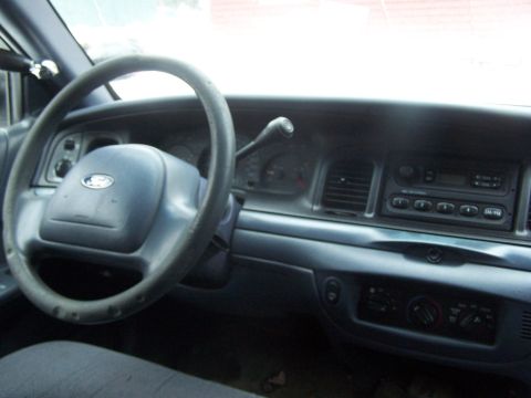 2001 Ford Crown Victoria - The interior of a 2001 Ford Crown Victoria, its dashboard, steering wheel, and center console.