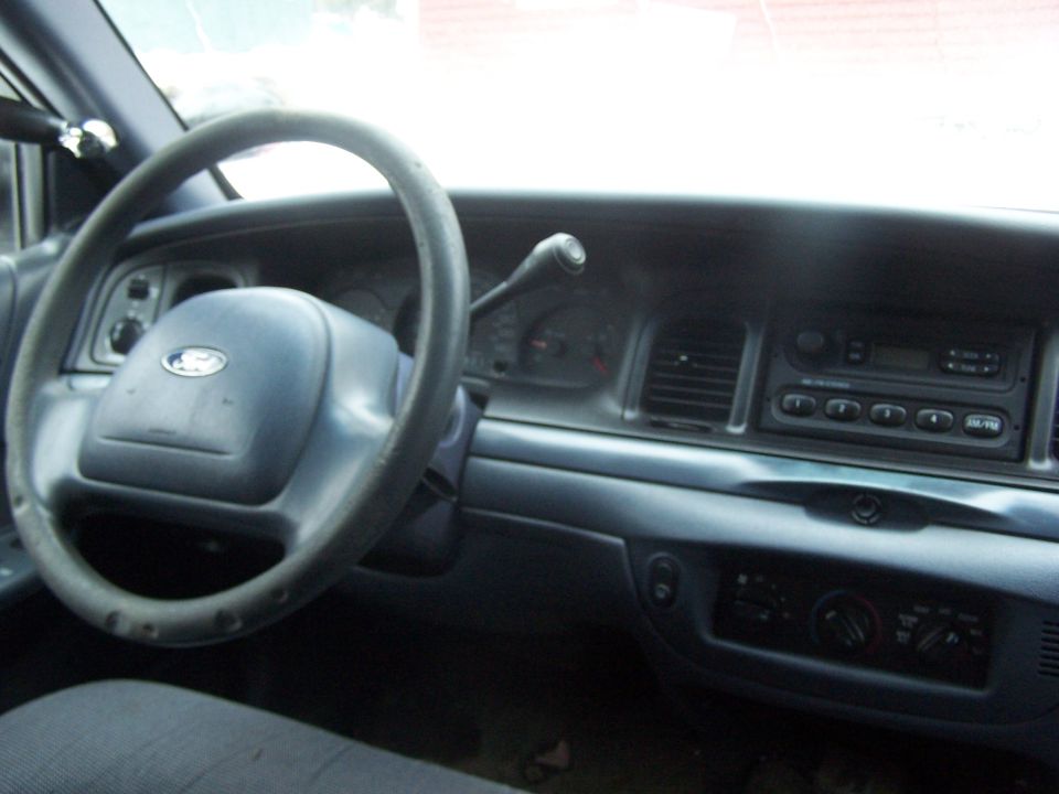 Interior of a 2001 Ford Crown Victoria showing the dashboard and steering wheel