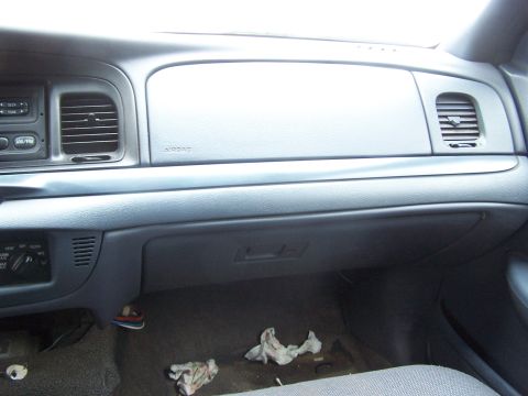 2001 Ford Crown Victoria - The dashboard of a car is visible, with an airbag indicator and air vents.