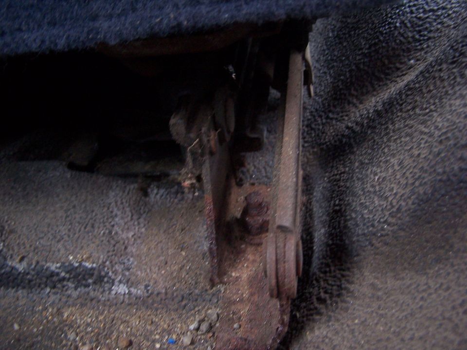 Interior seat bracket with rust and wear