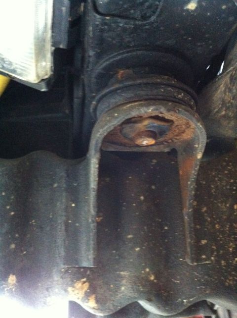 1996 Ford Bronco - This photo shows a rusty body mount bushing, a part of the vehicle's frame.
