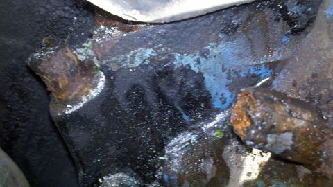 1978 Ford Bronco - Engine block shows signs of corrosion and residue, possibly from a coolant leak.