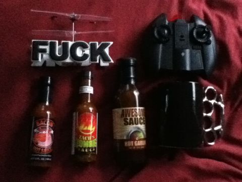 2006 Ford E350 - Collection of items including a remote control helicopter, hot sauce bottles, and a mug.