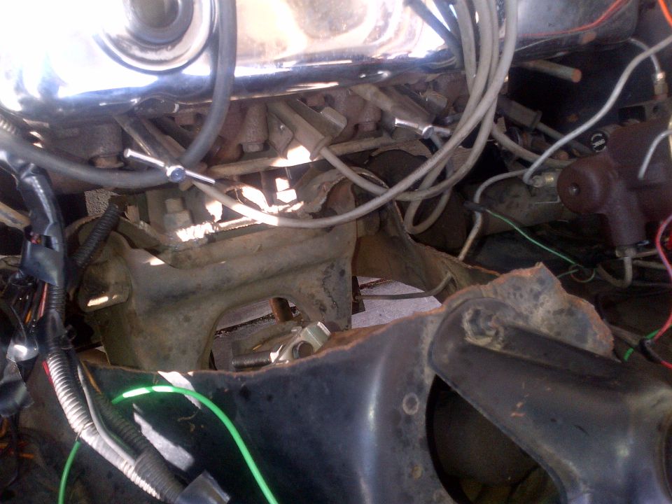 Close-up of engine bay with wiring and metal parts visible
