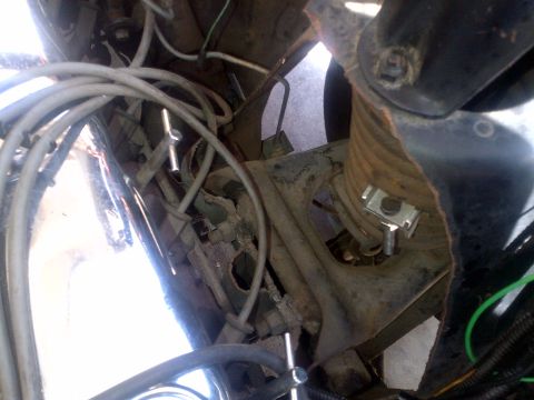 1965 Ford Mustang - This image shows a close-up view of various mechanical components and wiring within a vehicle's engine bay.