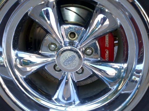 1965 Ford Mustang - Close-up of a chrome wheel with a red brake caliper that has 'SSBC POR' visible.