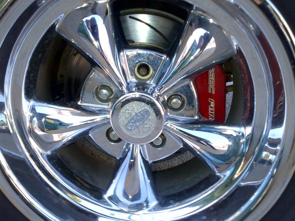 Chrome wheel with red brake caliper showing 'SSBC POR' text