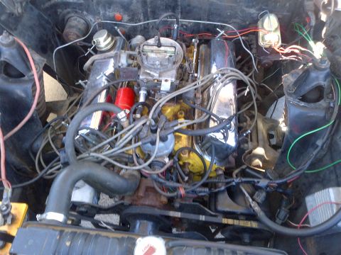 1965 Ford Mustang - Close-up view of a V8 engine in an engine bay, various components and wiring.