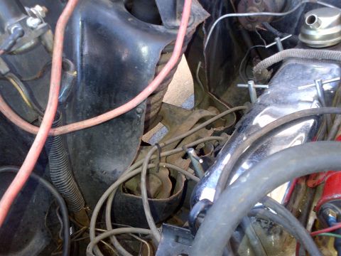 1965 Ford Mustang - Close-up view of the engine bay of a 1965 Ford Mustang, showing various components and wiring.