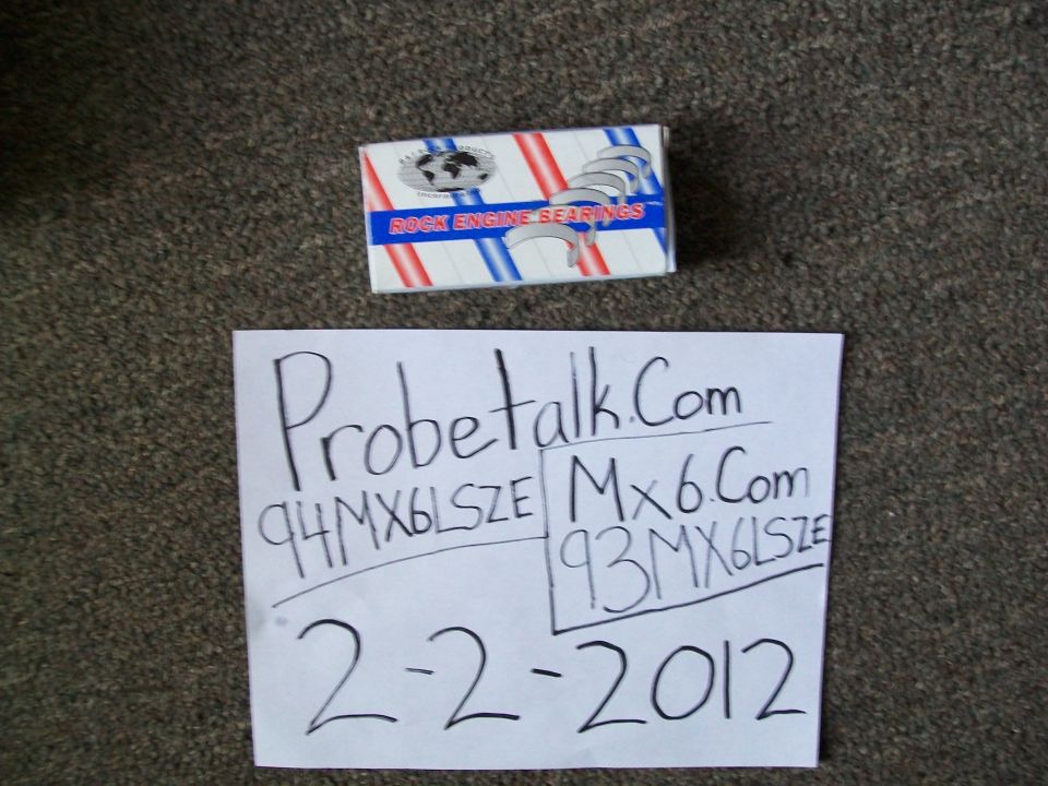 Box of engine bearings and paper with 'Probetalk.Com 94MX6LSZE Mx6.Com 93MX6LSZE 2-2-2012' written on it