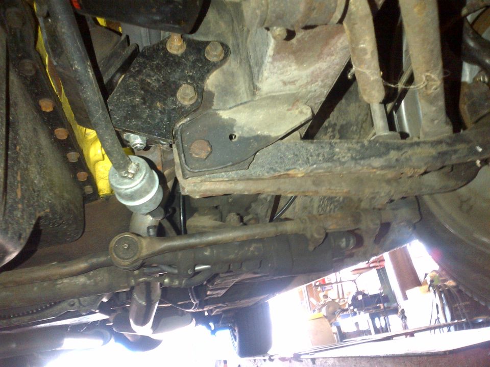 Undercarriage view of steering linkage and suspension components
