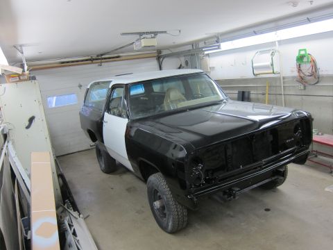 1987 Dodge 1500 - 1987 Dodge Ramcharger in a garage, showing its bodywork in progress with contrasting black and white panels.