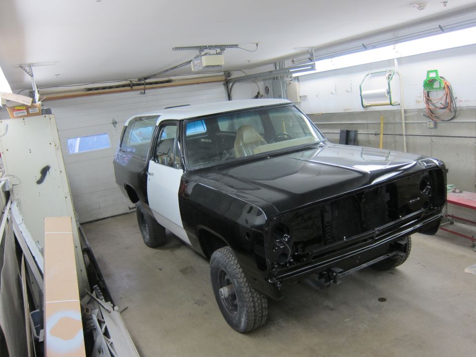 1987 Dodge Ramcharger with black and white paint in a garage, undergoing bodywork