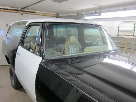 1987 Dodge 1500 - Side view of a 1987 Dodge Ramcharger with its interior visible, in the process of bodywork.