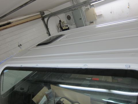 1987 Dodge 1500 - The top of a white truck shows a sunroof and ribbed paneling.