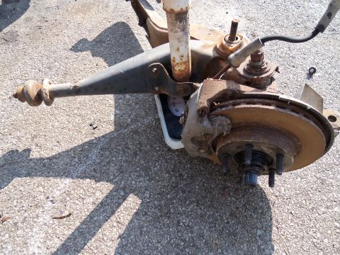 1987 Ford Ranger - A heavily rusted suspension component is shown on a scale, suggesting it is being weighed for removal or sale.
