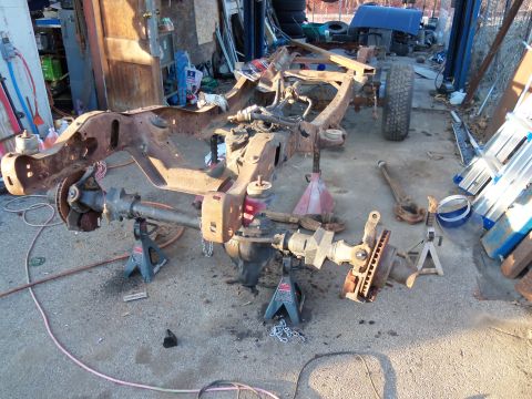 1987 Ford Ranger - Truck frame and suspension parts laid out in a workshop for repair or restoration.