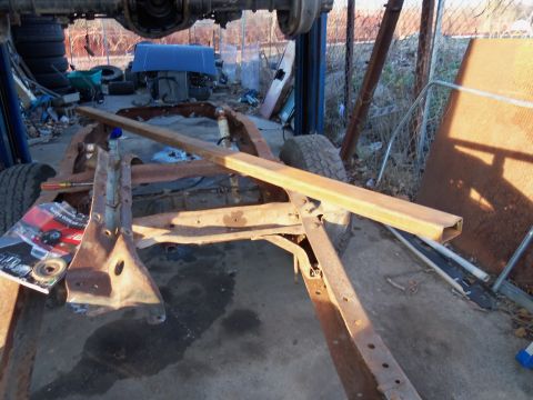 1987 Ford Ranger - The bare frame of a truck is visible, suspended for repair or disassembly.