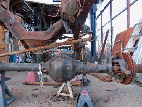 1987 Ford Ranger - Vehicle axle assembly and frame components are shown disassembled and supported by jack stands.