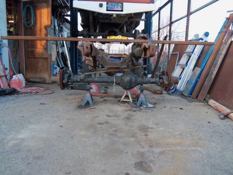 1987 Ford Ranger - A vehicle's front axle assembly is disassembled and supported by jack stands.