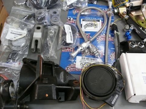 1976 Chevrolet Corvette - Various automotive components are laid out, suggesting a project or repair in progress.