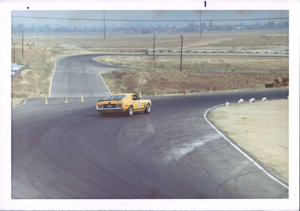 yellow race car with number 15 on door driving on a track
