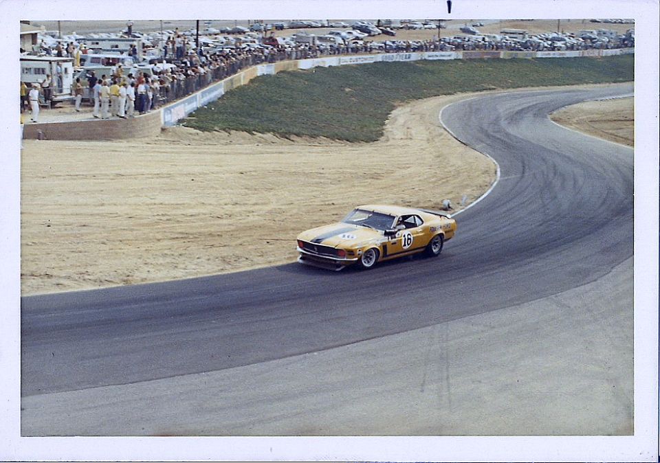 Yellow 1970 race car with number 16 on door on track