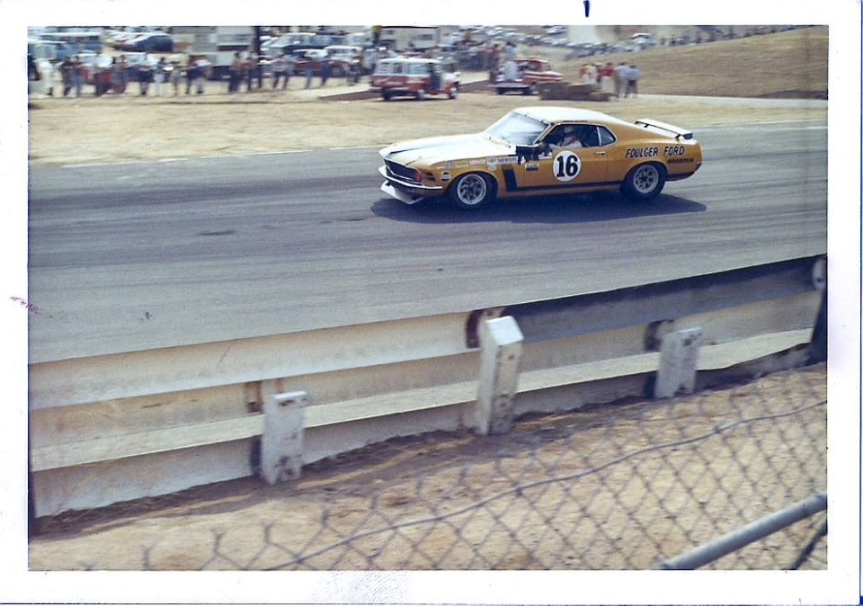 Yellow race car with number 16 and "FOLLMER FORD" text, 3/4 front view