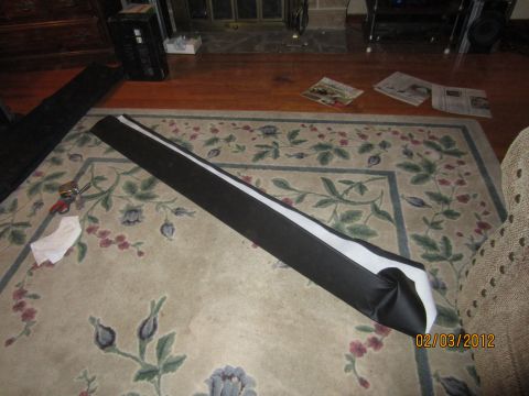 1979 Ford Bronco - A car part lies on a rug next to tools and newspapers, with a date stamp of 02/03/2012.