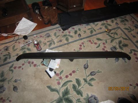 1979 Ford Bronco - A car part lies on a patterned rug next to various household items and a SuperMotors watermark.