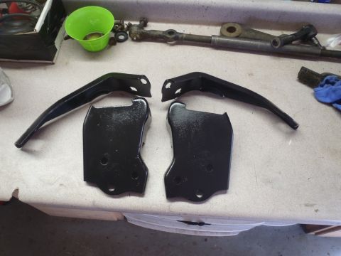 1979 Ford Bronco - Automotive suspension and steering components are laid out on a workbench for inspection or repair.