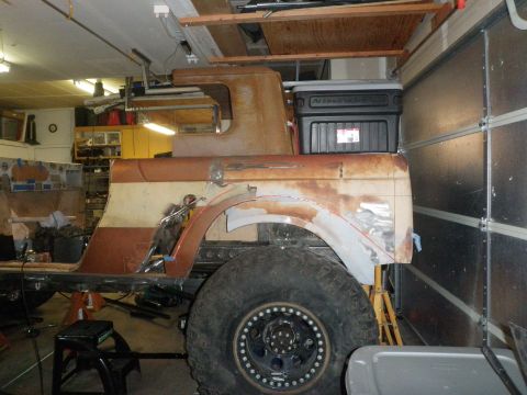 1961 International Scout 800 - This is a rusted pickup truck body undergoing restoration in a garage.