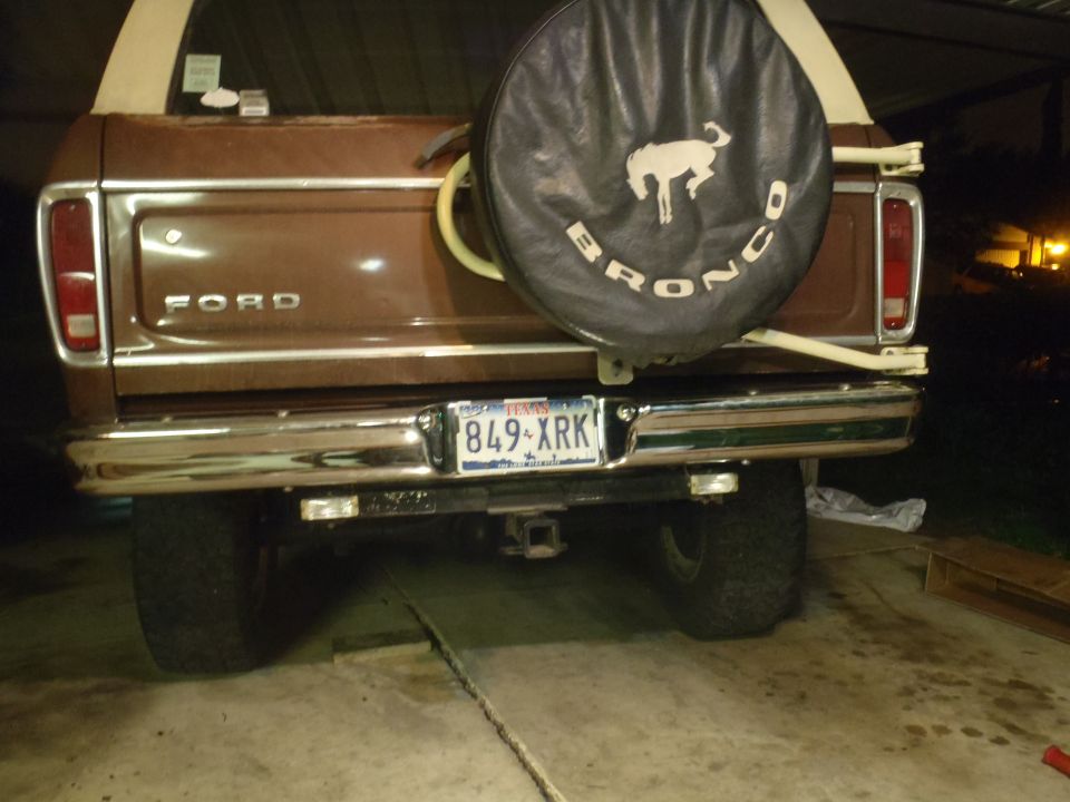 Rear view of a brown 1979 Ford Bronco with a spare tire carrier and Texas license plate 849-XRK